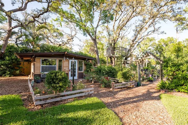 a living room with furniture a flat screen tv and a large window