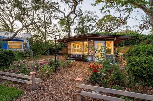a living room with furniture and a floor to ceiling window next to a larger window