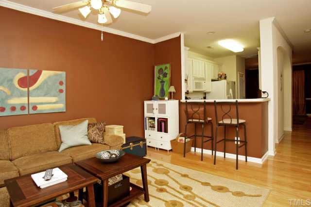 8322 City Loft Court Raleigh, NC 27613 - Photo 4 of 12 a living room with furniture and a dining table with wooden floor