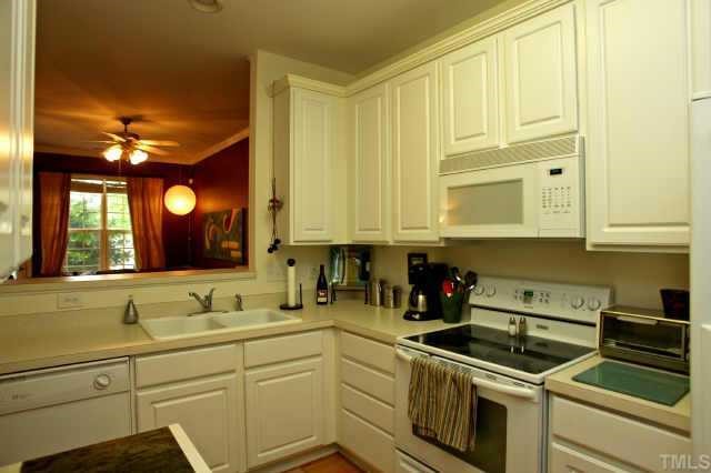 8322 City Loft Court Raleigh, NC 27613 - Photo 5 of 12 a kitchen with stainless steel appliances granite countertop a sink and cabinets