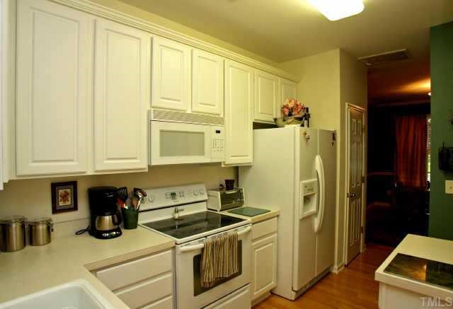 8322 City Loft Court Raleigh, NC 27613 - Photo 6 of 12 a kitchen with stainless steel appliances granite countertop a refrigerator and a stove