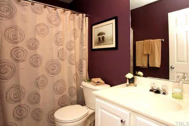 8322 City Loft Court Raleigh, NC 27613 - Photo 9 of 12 a bathroom with a granite countertop toilet sink and mirror