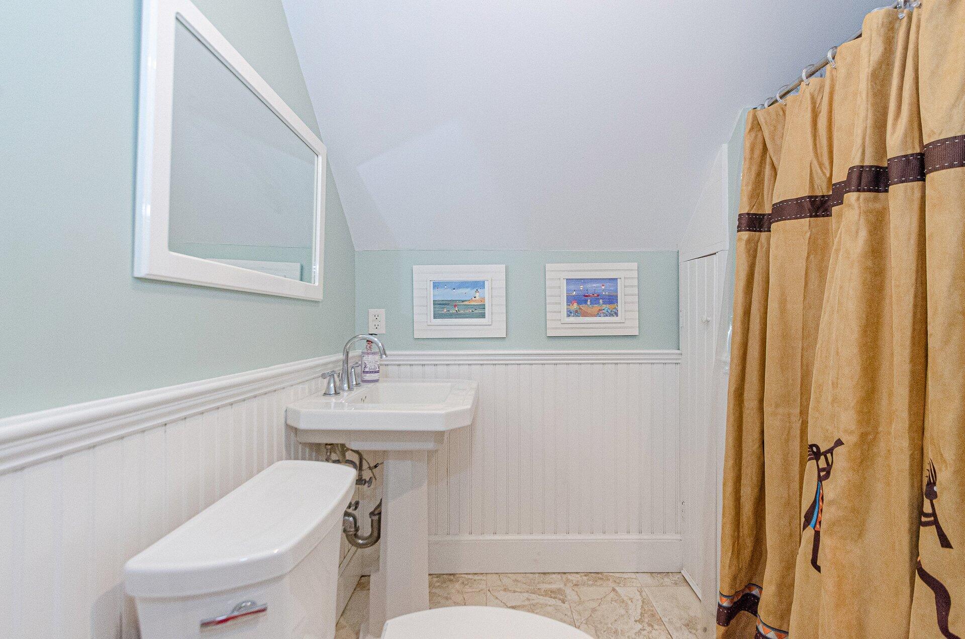 1089 Main Street Cotuit, MA 02635 - Photo 32 of 41 a bathroom with a sink a toilet and shower curtain