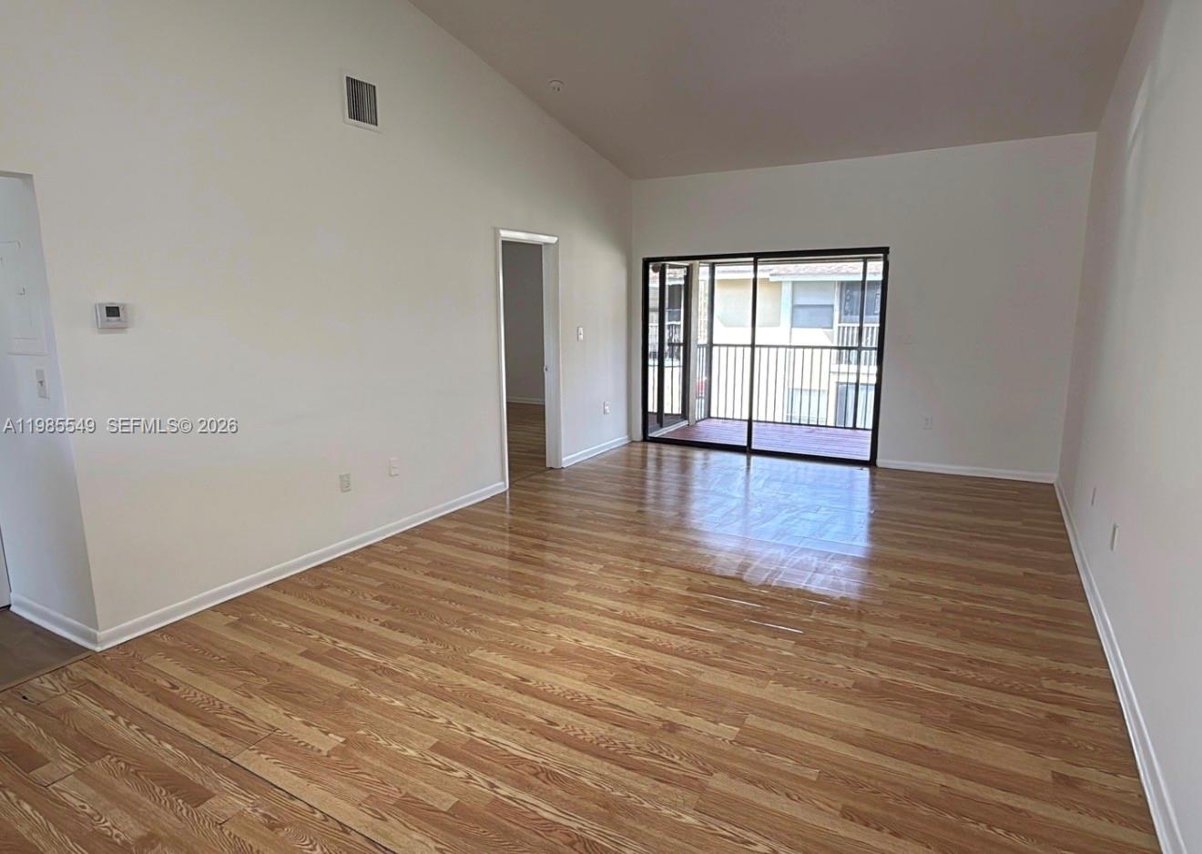 2255 Southwest 80th Terrace, Unit 2255 Miramar, FL 33025 - Photo 2 of 14 wooden floor in an empty room with a window