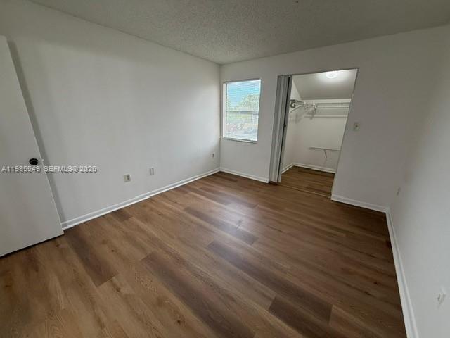 2255 Southwest 80th Terrace, Unit 2255 Miramar, FL 33025 - Photo 5 of 14 an empty room with wooden floor and windows
