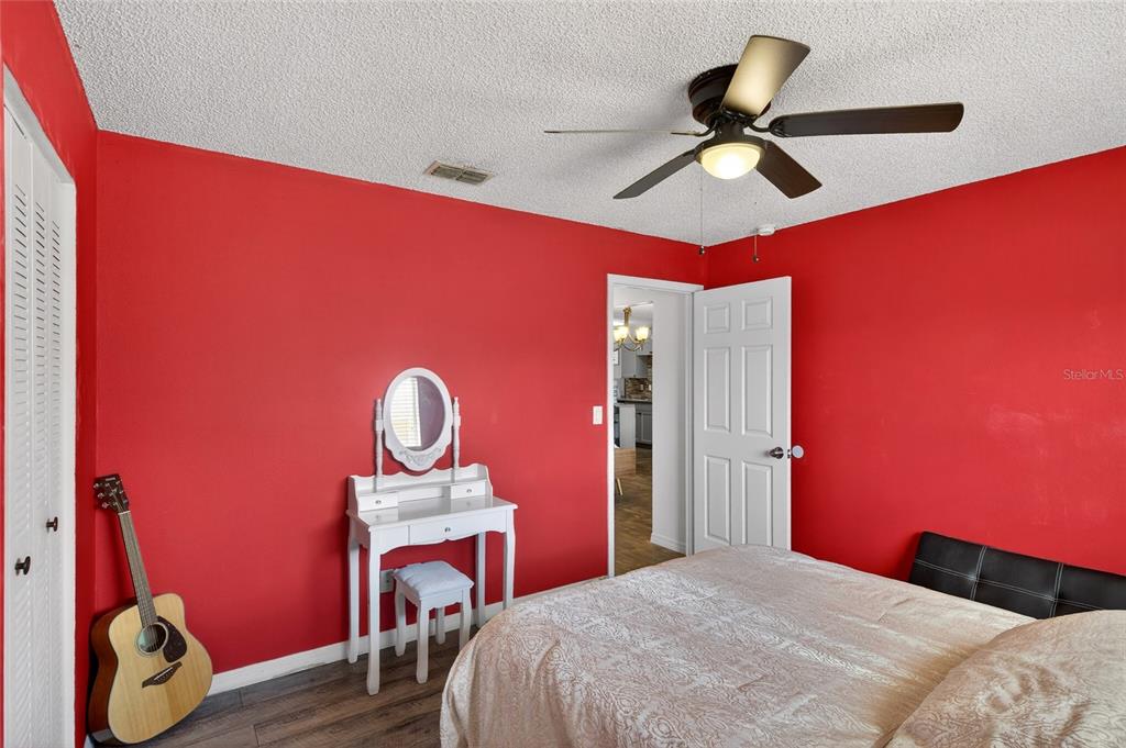622 Ridge Terrace Winter Haven, FL 33881 - Photo 14 of 34 a bedroom with a bed and a chandelier