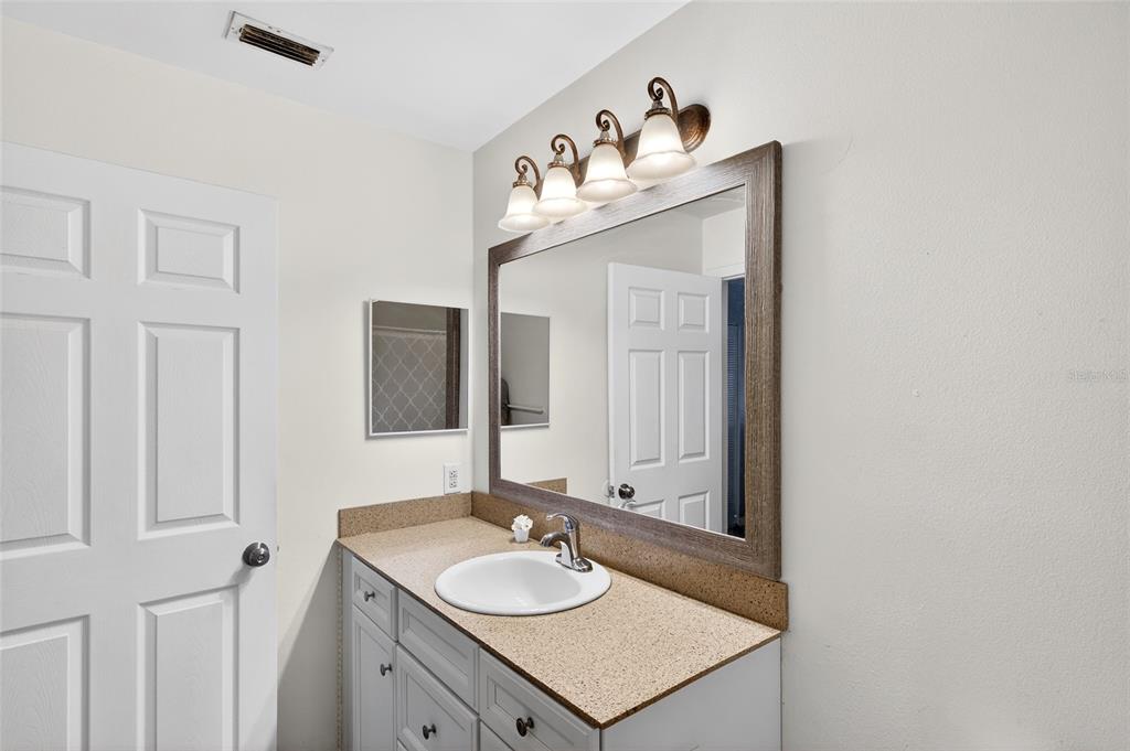622 Ridge Terrace Winter Haven, FL 33881 - Photo 22 of 34 a bathroom with a sink and a mirror