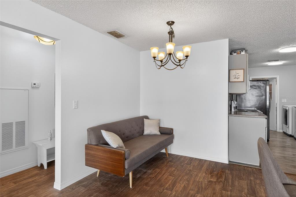 622 Ridge Terrace Winter Haven, FL 33881 - Photo 6 of 34 a view of a livingroom with furniture wooden floor and chandelier