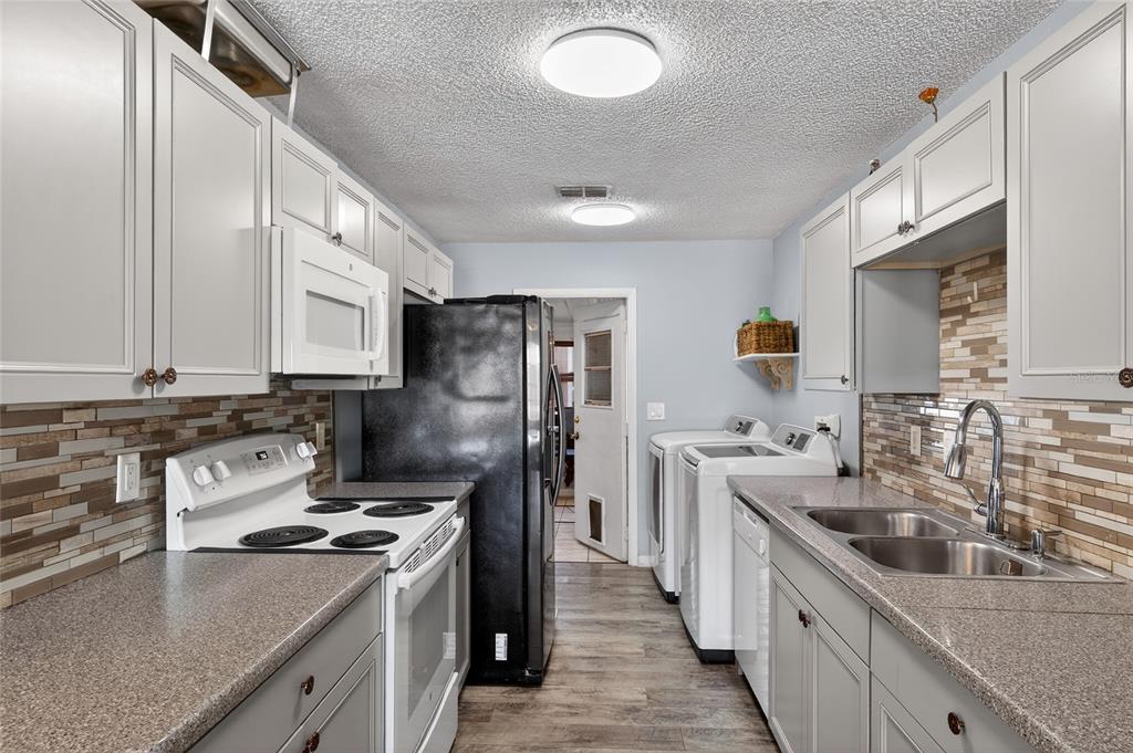 622 Ridge Terrace Winter Haven, FL 33881 - Photo 9 of 34 a kitchen with stainless steel appliances granite countertop a sink stove and refrigerator