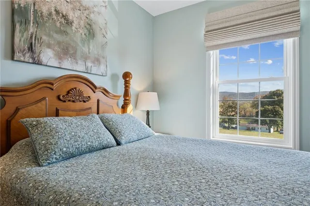 a bedroom with a bed and window