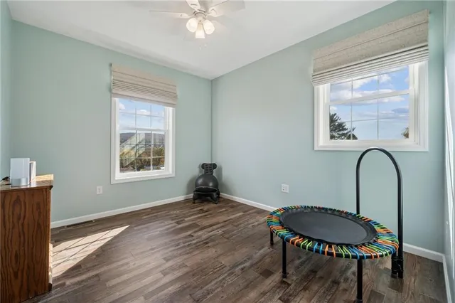 a room with a table chairs and a window