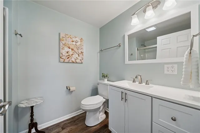 a bathroom with a toilet sink and mirror