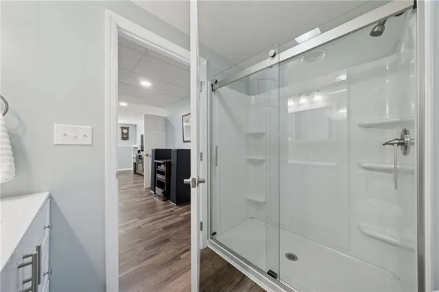 a bathroom with a glass shower door