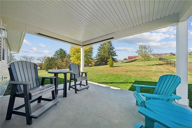 a view of a chairs and table in patio with a garden