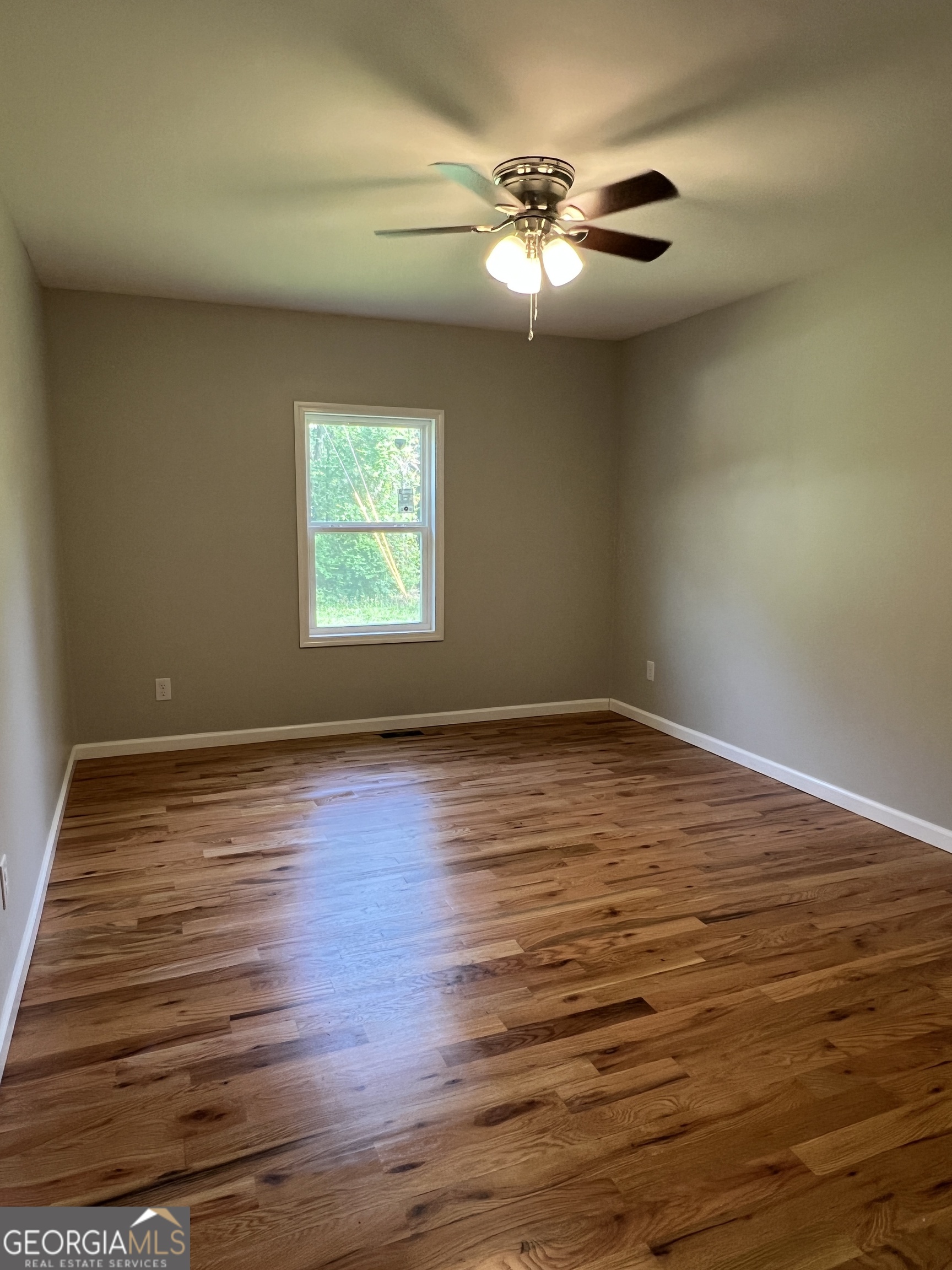 984 Plowshare Road Carrollton, GA 30117 - Photo 10 of 15 a view of an empty room with wooden floor and a window