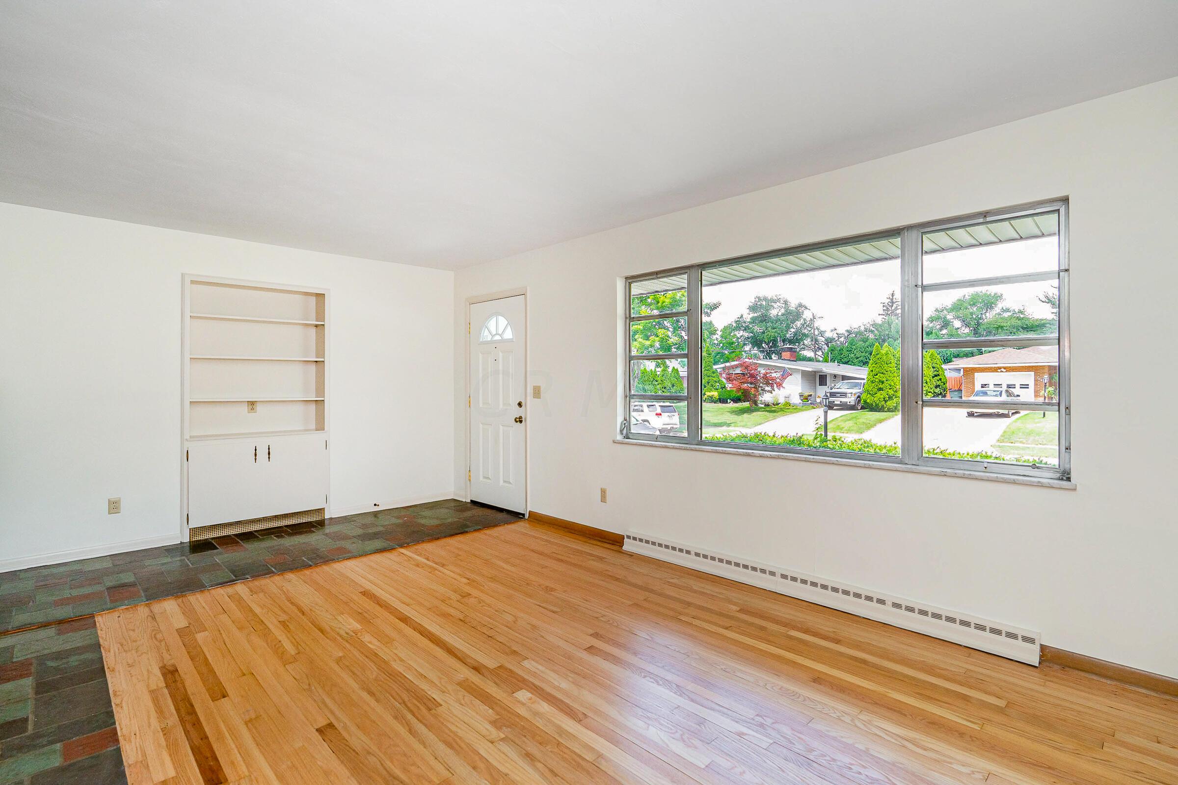 1017 Fordham Road Columbus, OH 43224 - Photo 5 of 30 Living room with newly refinished wood floors & built-in shelving.