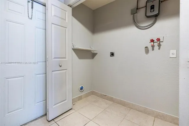 a view of an empty room with window and cabinet