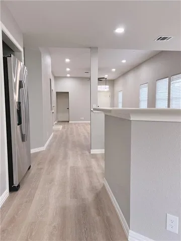 a view of a kitchen with a sink and wooden floor