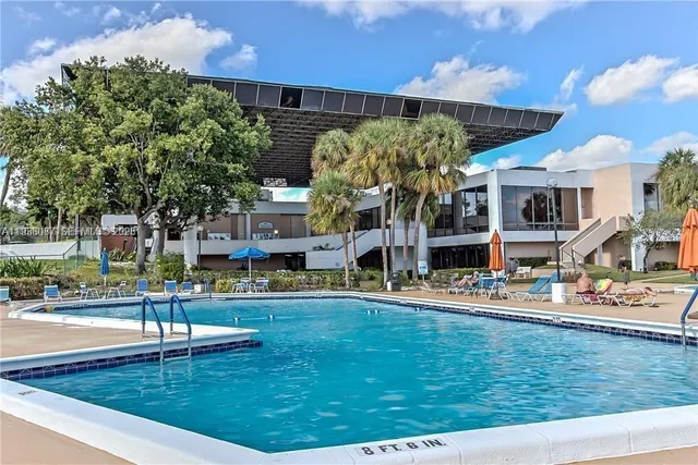 a view of a swimming pool and a yard