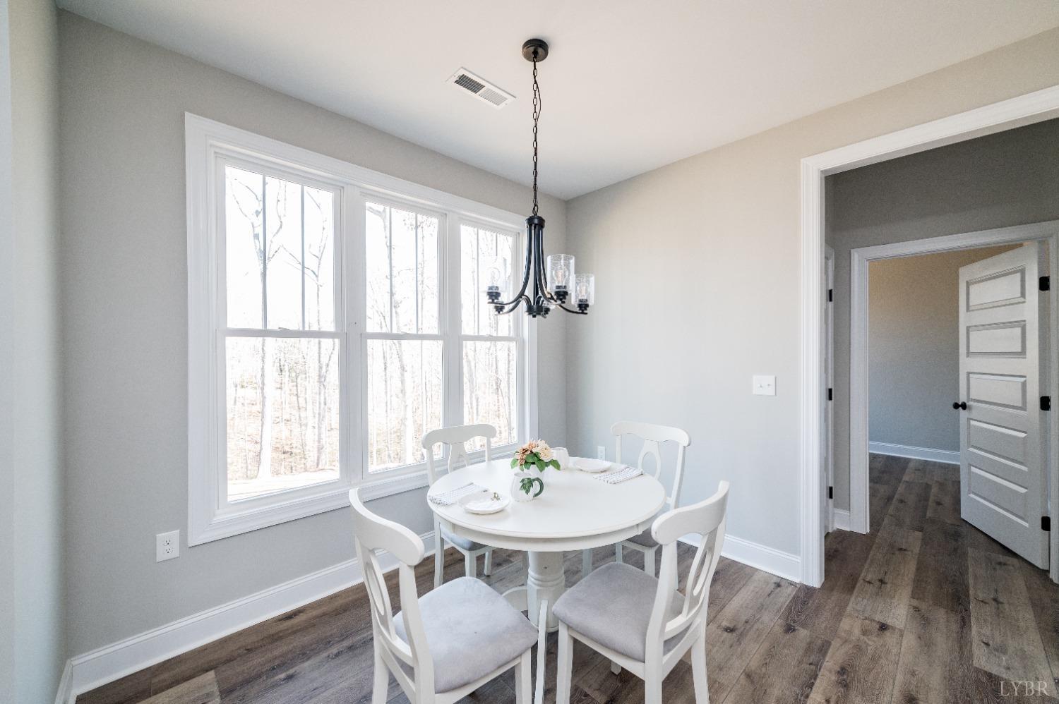 506 Bridge Tree Court Evington, VA 24550 - Photo 11 of 60 a view of a dining room with furniture window and wooden floor