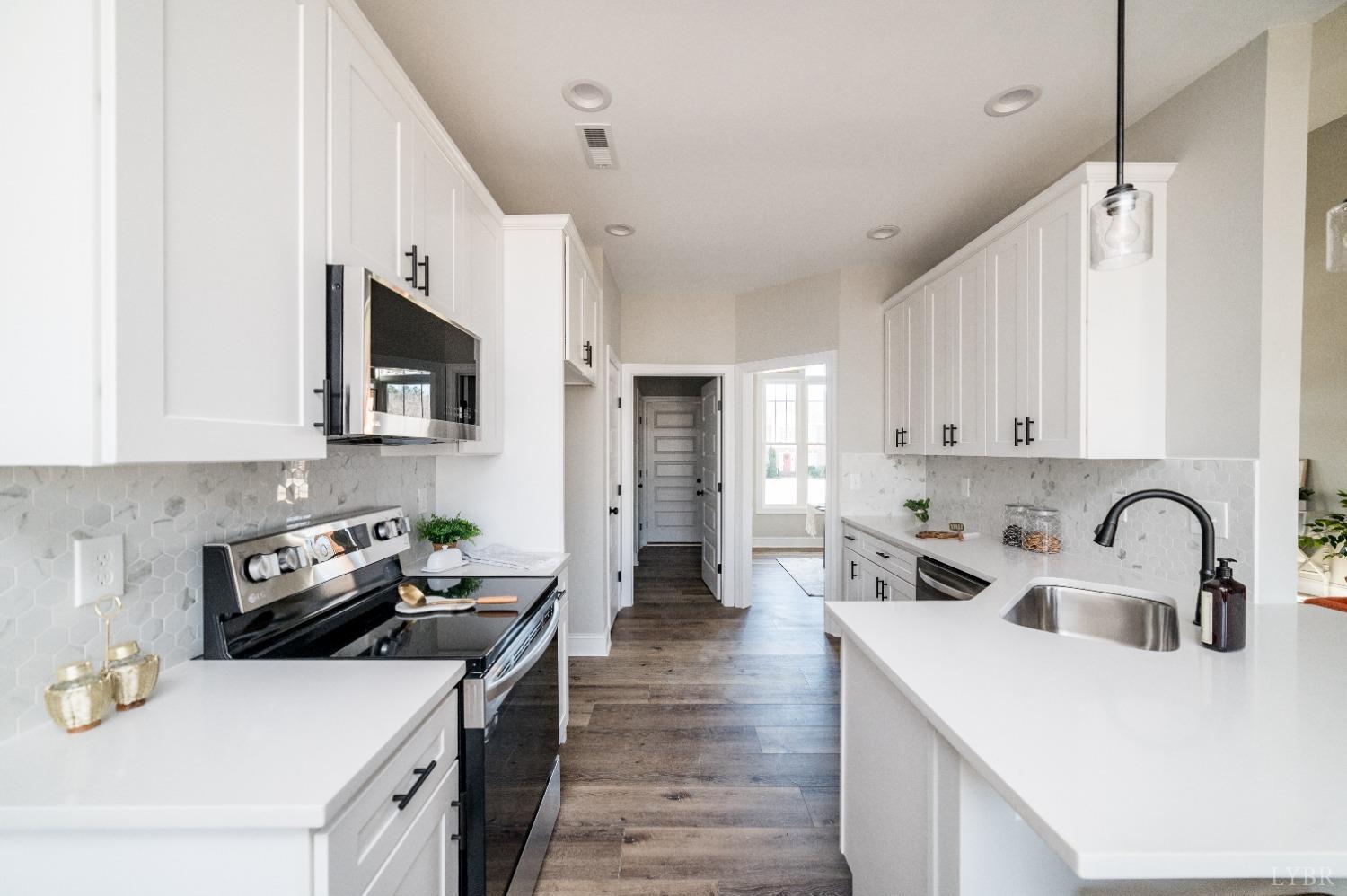 506 Bridge Tree Court Evington, VA 24550 - Photo 14 of 60 a kitchen with a sink a stove and cabinets