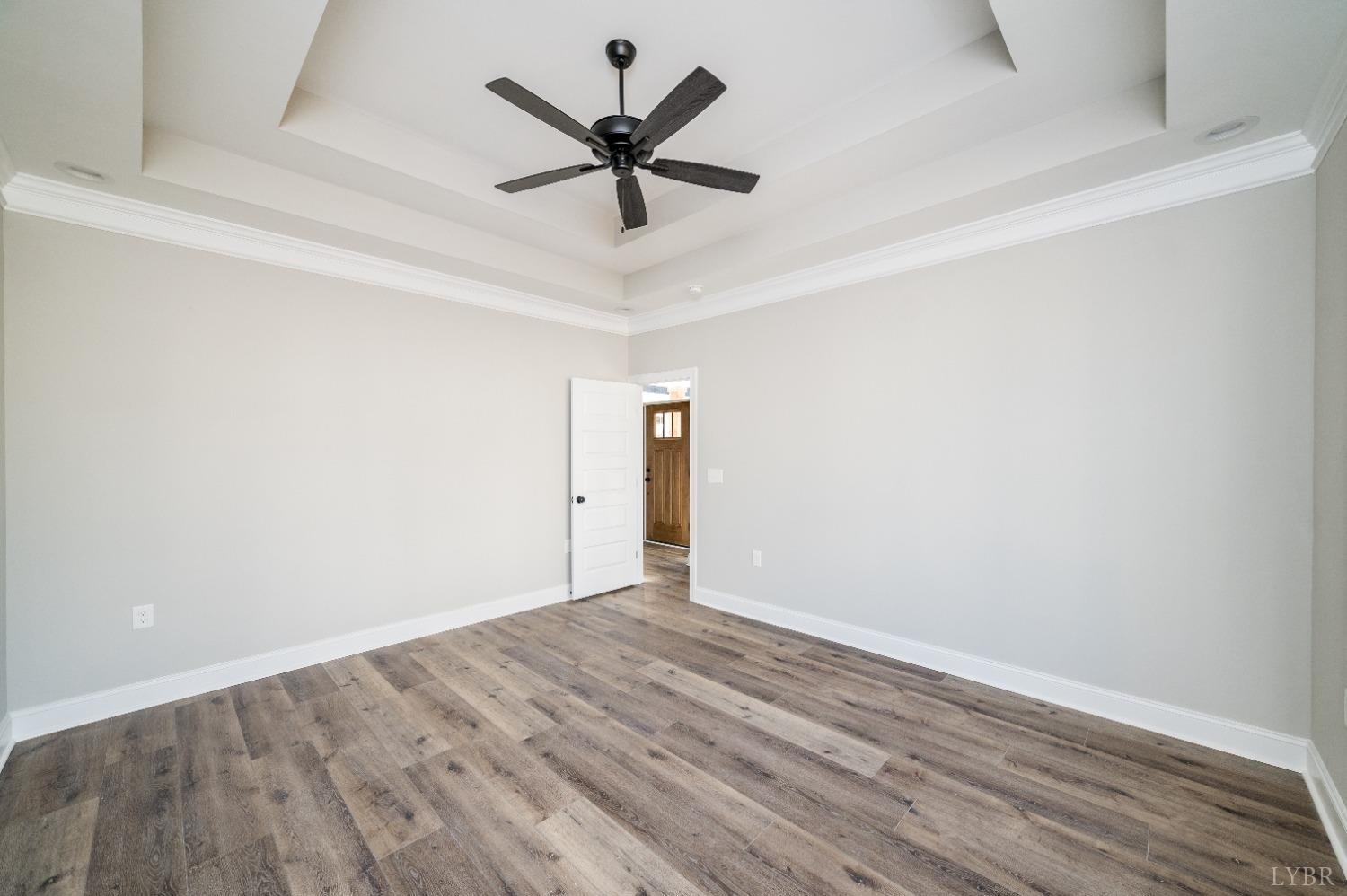 506 Bridge Tree Court Evington, VA 24550 - Photo 23 of 60 an empty room with wooden floor and ceiling fan