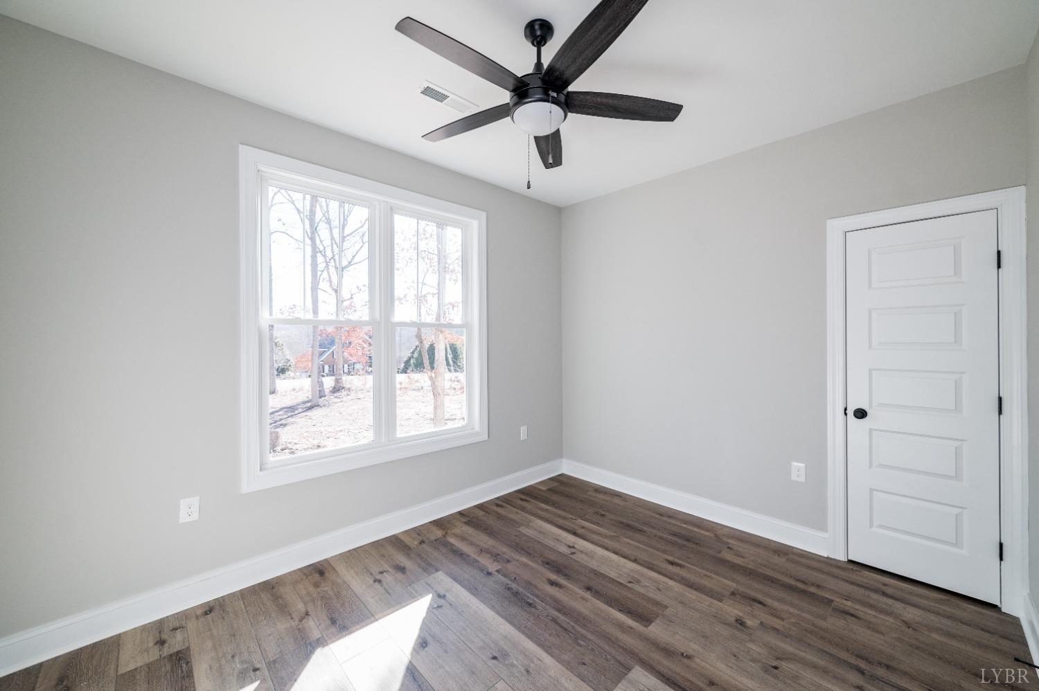 506 Bridge Tree Court Evington, VA 24550 - Photo 36 of 60 a view of empty room with wooden floor and fan