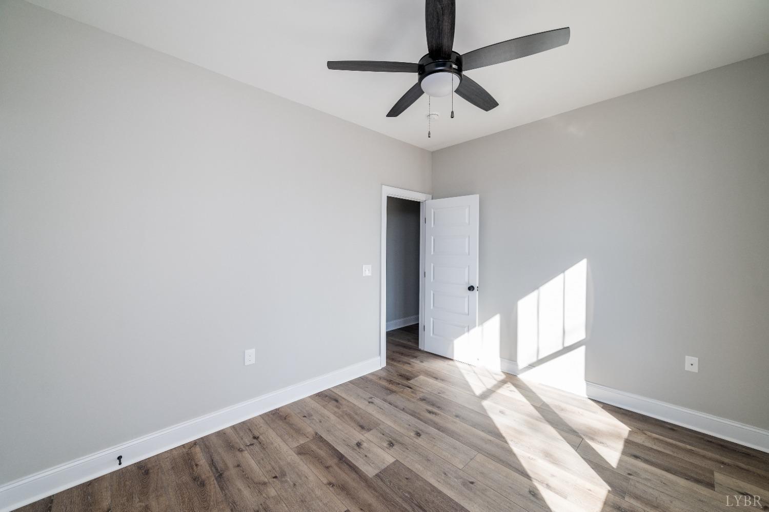 506 Bridge Tree Court Evington, VA 24550 - Photo 37 of 60 a view of an empty room with wooden floor and a window