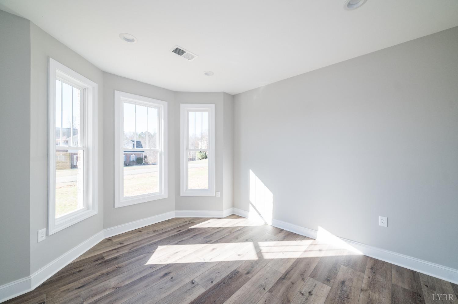 506 Bridge Tree Court Evington, VA 24550 - Photo 38 of 60 a view of empty room with wooden floor and fan