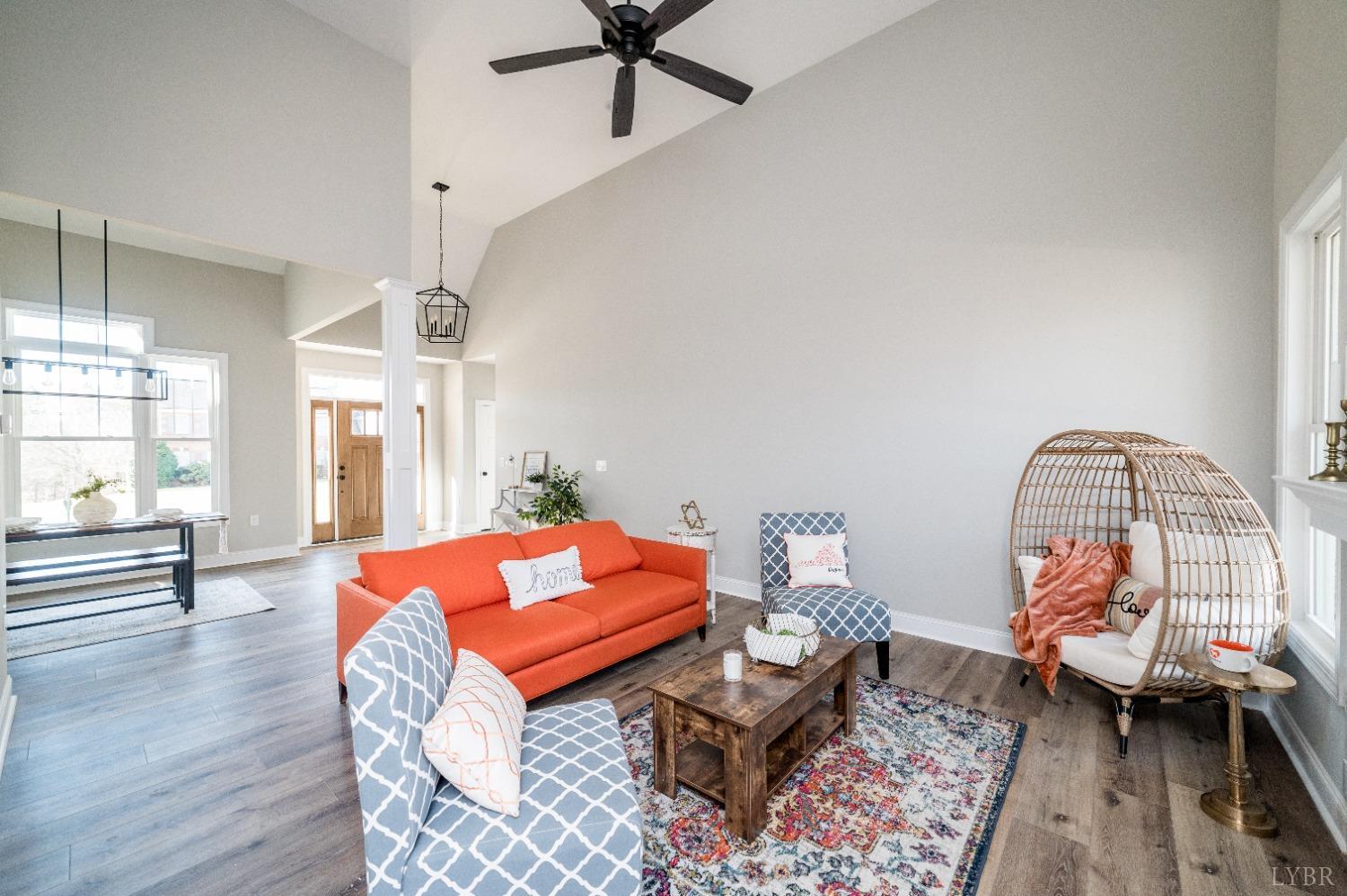 506 Bridge Tree Court Evington, VA 24550 - Photo 10 of 60 a living room with furniture a rug and a chandelier