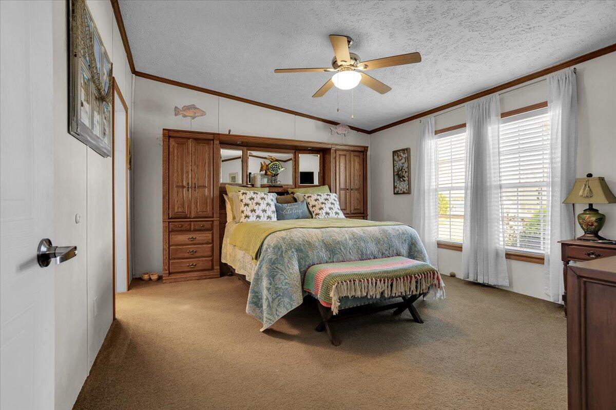 485 Big Cove Drive Penhook, VA 24137 - Photo 15 of 60 a bed room with a bed and a chandelier