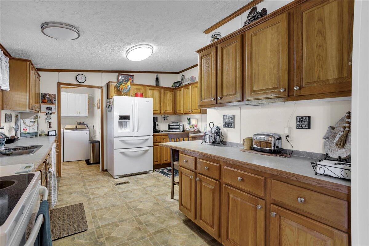 485 Big Cove Drive Penhook, VA 24137 - Photo 25 of 60 a kitchen with refrigerator and cabinets