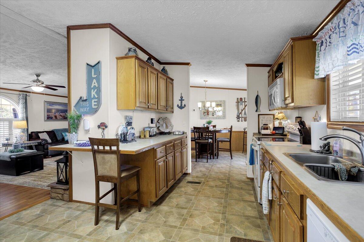 485 Big Cove Drive Penhook, VA 24137 - Photo 27 of 60 a kitchen with kitchen island granite countertop a sink and counter top space