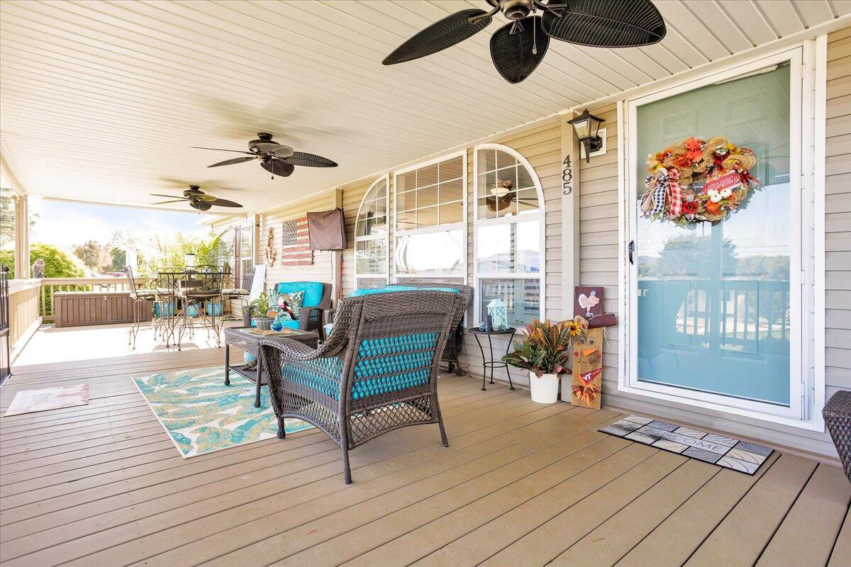 485 Big Cove Drive Penhook, VA 24137 - Photo 10 of 60 a living room with furniture and a floor to ceiling window