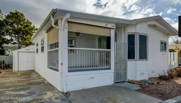 a view of a house with a wooden fence