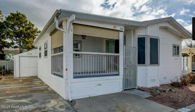 a view of a house with a wooden fence