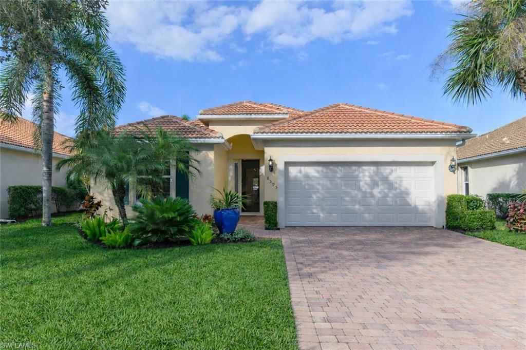 8595 Palermo Court Naples, FL 34114 - Photo 1 of 49 a front view of a house with garden