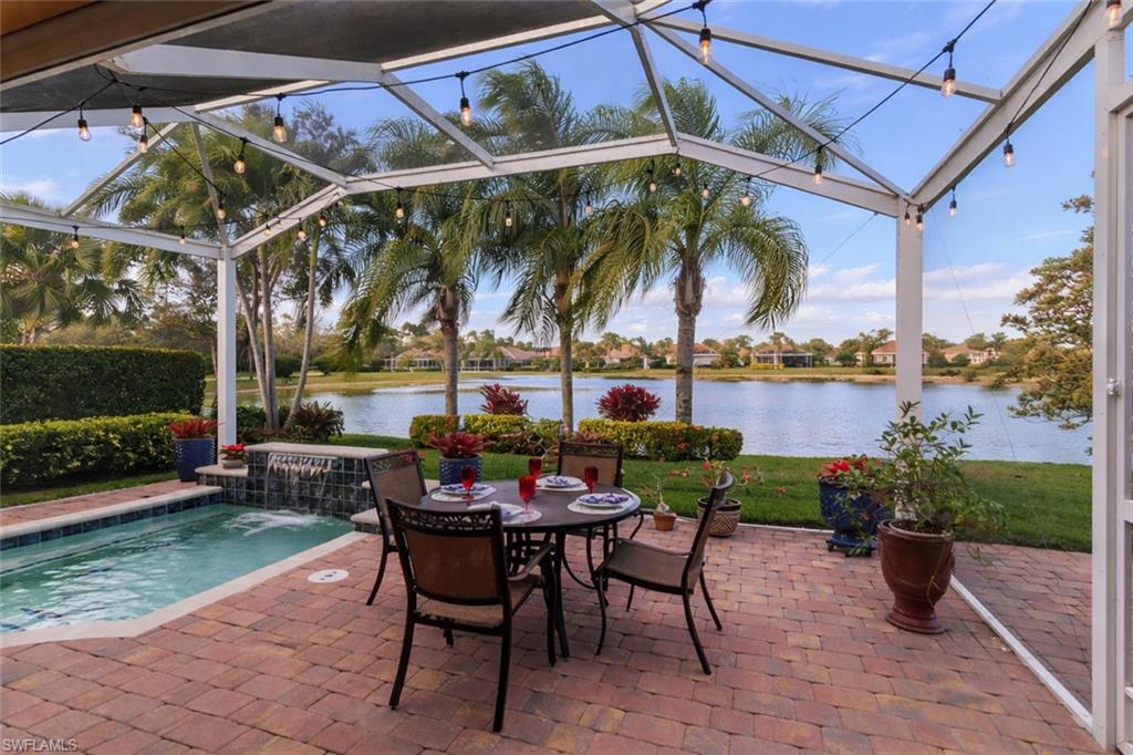 8595 Palermo Court Naples, FL 34114 - Photo 12 of 49 a view of a chairs and table in patio with a lake view