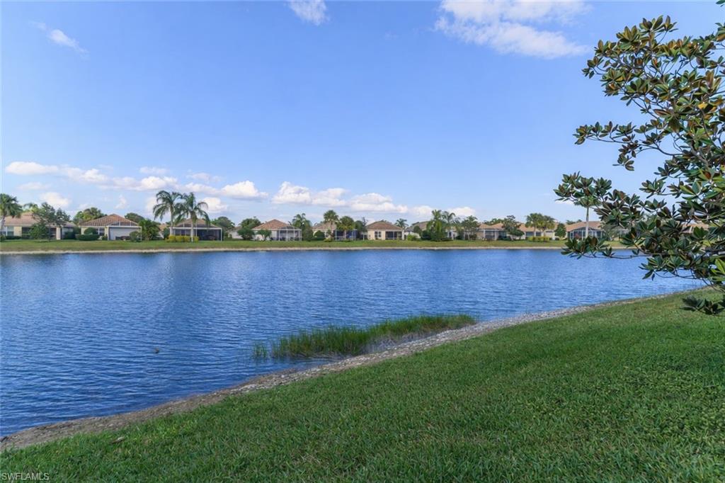 8595 Palermo Court Naples, FL 34114 - Photo 13 of 49 a view of a lake with houses in the back