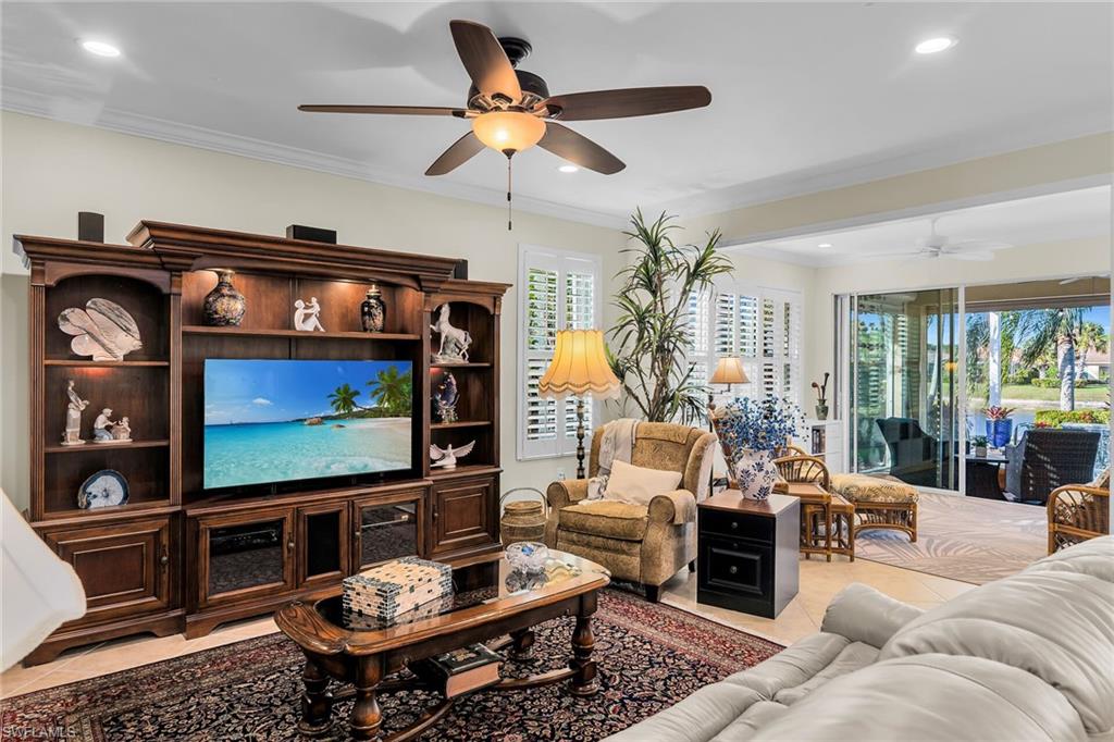 8595 Palermo Court Naples, FL 34114 - Photo 15 of 49 a living room with furniture and a flat screen tv