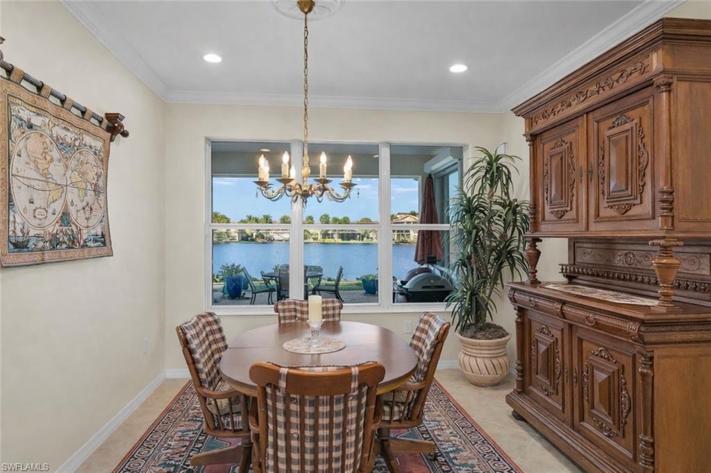 8595 Palermo Court Naples, FL 34114 - Photo 17 of 49 a view of a dining room with furniture a chandelier and wooden floor
