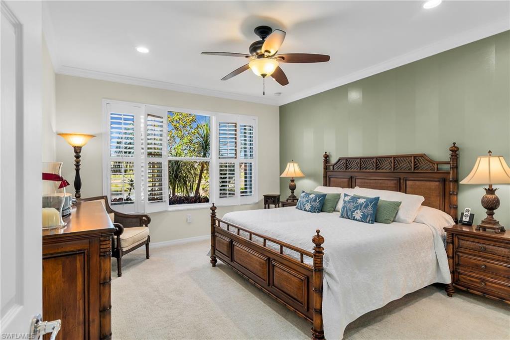 8595 Palermo Court Naples, FL 34114 - Photo 18 of 49 a bedroom with a bed and a chandelier