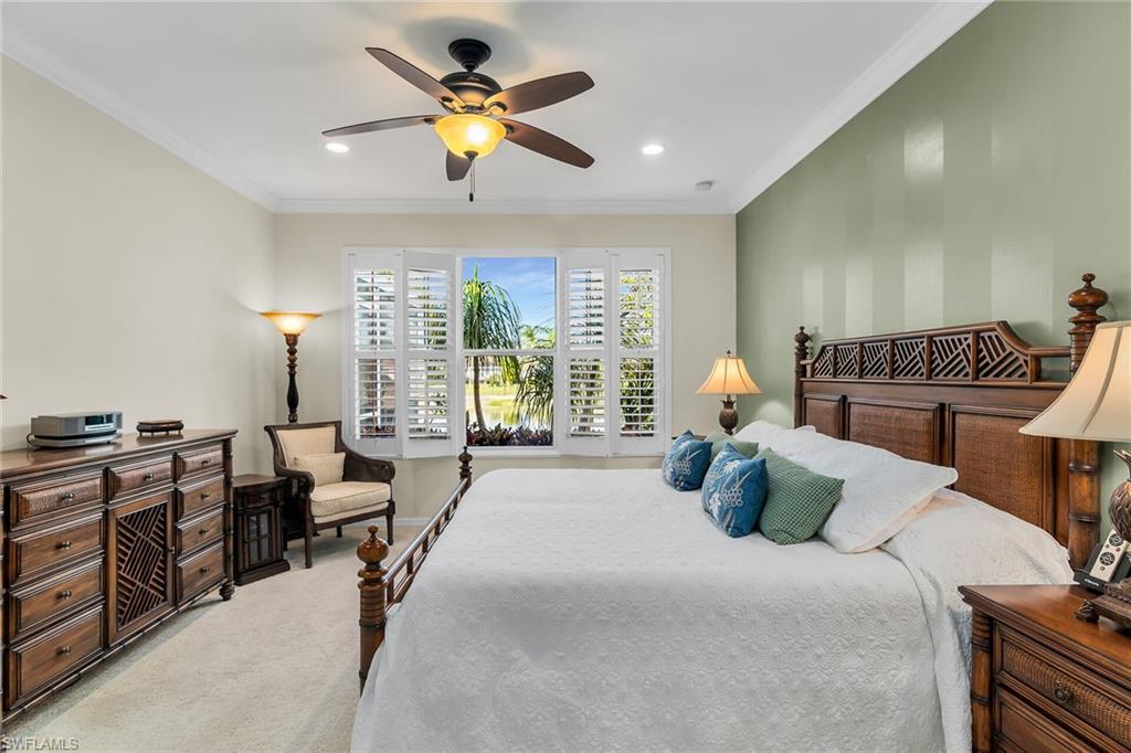 8595 Palermo Court Naples, FL 34114 - Photo 19 of 49 a bedroom with a bed chandelier and window