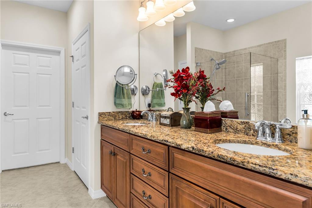 8595 Palermo Court Naples, FL 34114 - Photo 20 of 49 a bathroom with a granite countertop sink and a mirror