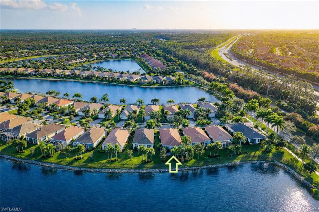8595 Palermo Court Naples, FL 34114 - Photo 2 of 49 an aerial view of residential houses with outdoor space and lake view