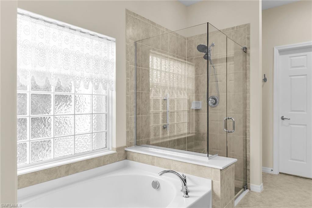8595 Palermo Court Naples, FL 34114 - Photo 21 of 49 a bathroom with a bathtub and a shower