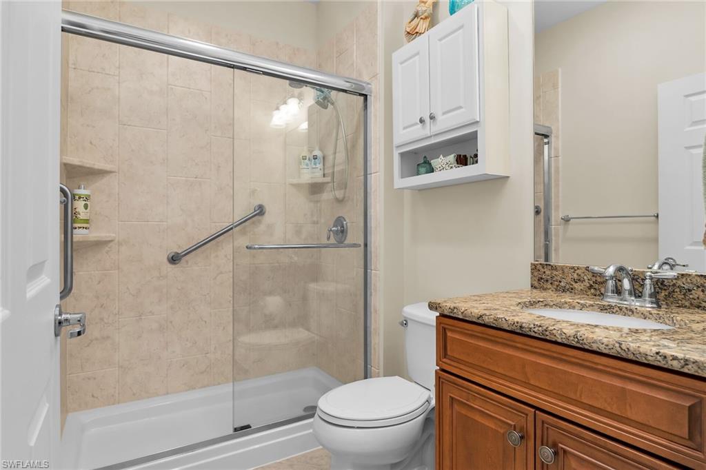 8595 Palermo Court Naples, FL 34114 - Photo 23 of 49 a bathroom with a granite countertop sink toilet and shower
