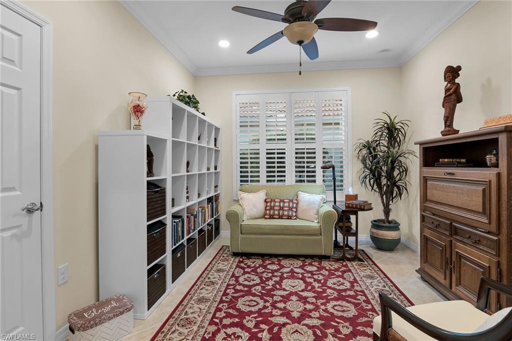 8595 Palermo Court Naples, FL 34114 - Photo 24 of 49 a living room with furniture and a fireplace
