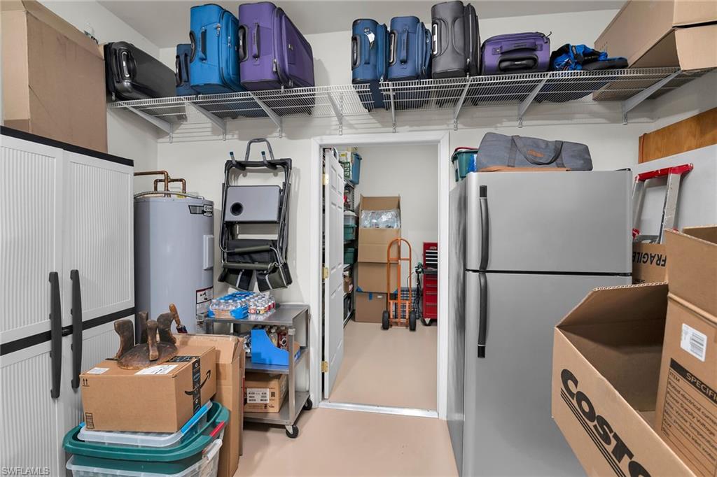 8595 Palermo Court Naples, FL 34114 - Photo 27 of 49 a view of storage and utility room with refrigerator and toys