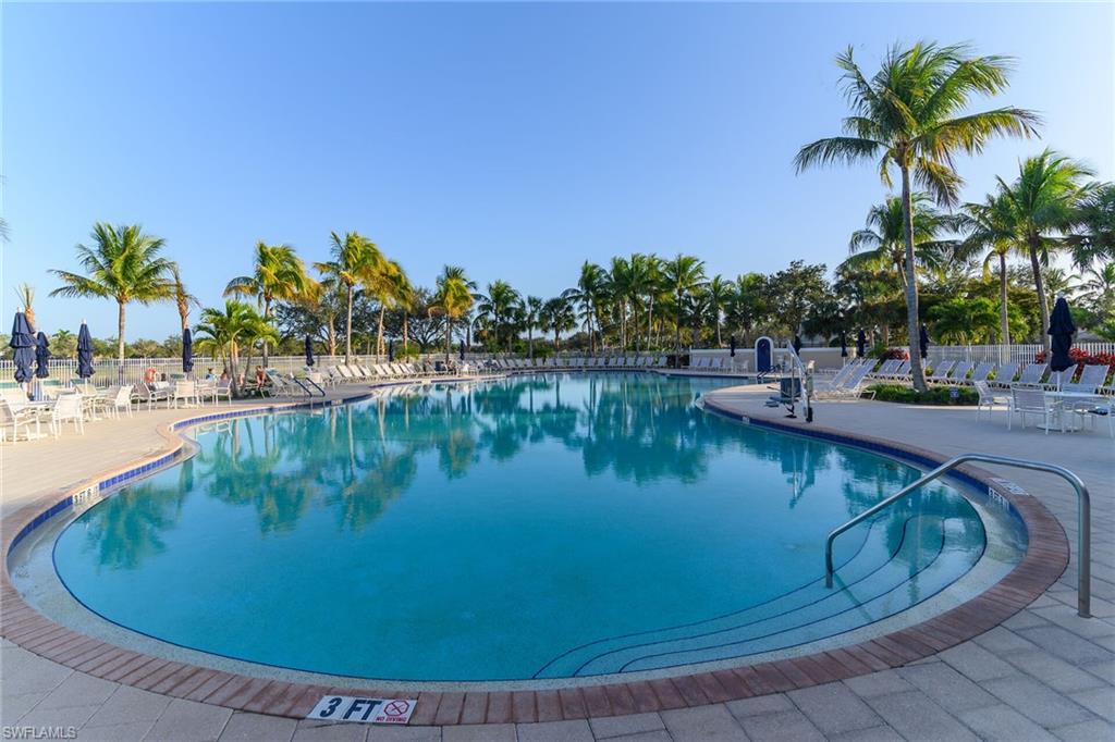8595 Palermo Court Naples, FL 34114 - Photo 42 of 49 a view of a swimming pool with a lawn chairs and palm tree